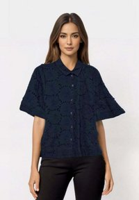 Navy blue short-sleeve button-up shirt with a subtle lace-like pattern, featuring a classic collar and relaxed fit. Smooth fabric texture.