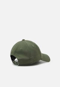 Olive green cotton cap with a curved brim, adjustable strap at the back, six-panel design, and small ventilation holes on the sides.