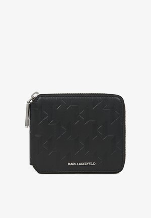 Must mustril nahkrahakott, millel on reljeefne geomeetriline muster, ümarad nurgad ja hõbedane tõmblukk metallist tõmblukuotsi kanssa. Brändinimi on esiküljel reljeefselt graveeritud.