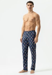 Marineblauwe pyjamabroek met een kleurrijk patroon van kleine cartoonfiguren, gemaakt van zachte stof met een elastische tailleband en rechte pijpen.