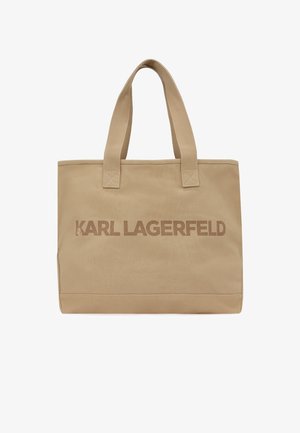 Béžová taška z látky s dvoma rukoväťami a nápisom "KARL LAGERFELD" potlačeným na prednej strane v zhodných béžových tónoch.