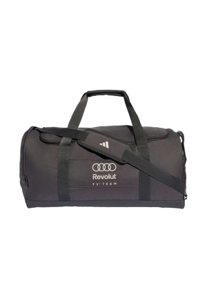 Sac de sport noir avec deux poignées, bandoulière réglable et logo blanc Audi Revolut F1 Team sur le devant.