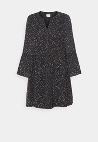 Musta mekko, jossa on pyöreä pääntie, pitkät kellohihat, napitus edessä ja valkoista ja ruosteenväristä laikkujen kuviointia kauttaaltaan. Kevyt kangas.