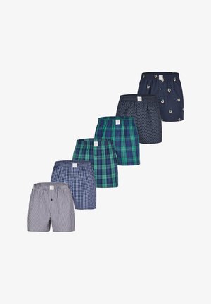 Boxers pour homme avec différents motifs : rayures bleues, tartan vert, pois gris et impression de canard. Tissu en coton, taille élastique, boutons.