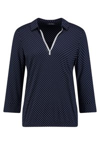 Marinebluse mit einem halben Reißverschluss und weißem Saum, versehen mit einem gepunkteten Muster in hellblauen Farbtönen auf einem glatten Stoff.