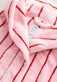 Pink plush robe with red stripes, featuring a hood, soft texture, and a tag displaying "NEXT time to dream."