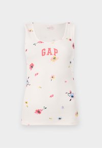 Débardeur côtelé couleur crème, arborant un logo "GAP" rose. Décoré de petits motifs floraux dans diverses couleurs. Design ajusté, sans manches.