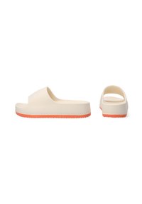 Light beige slide sandals made of rubber, featuring a wide strap, an orange accent on the sole, and a smooth, textured finish.