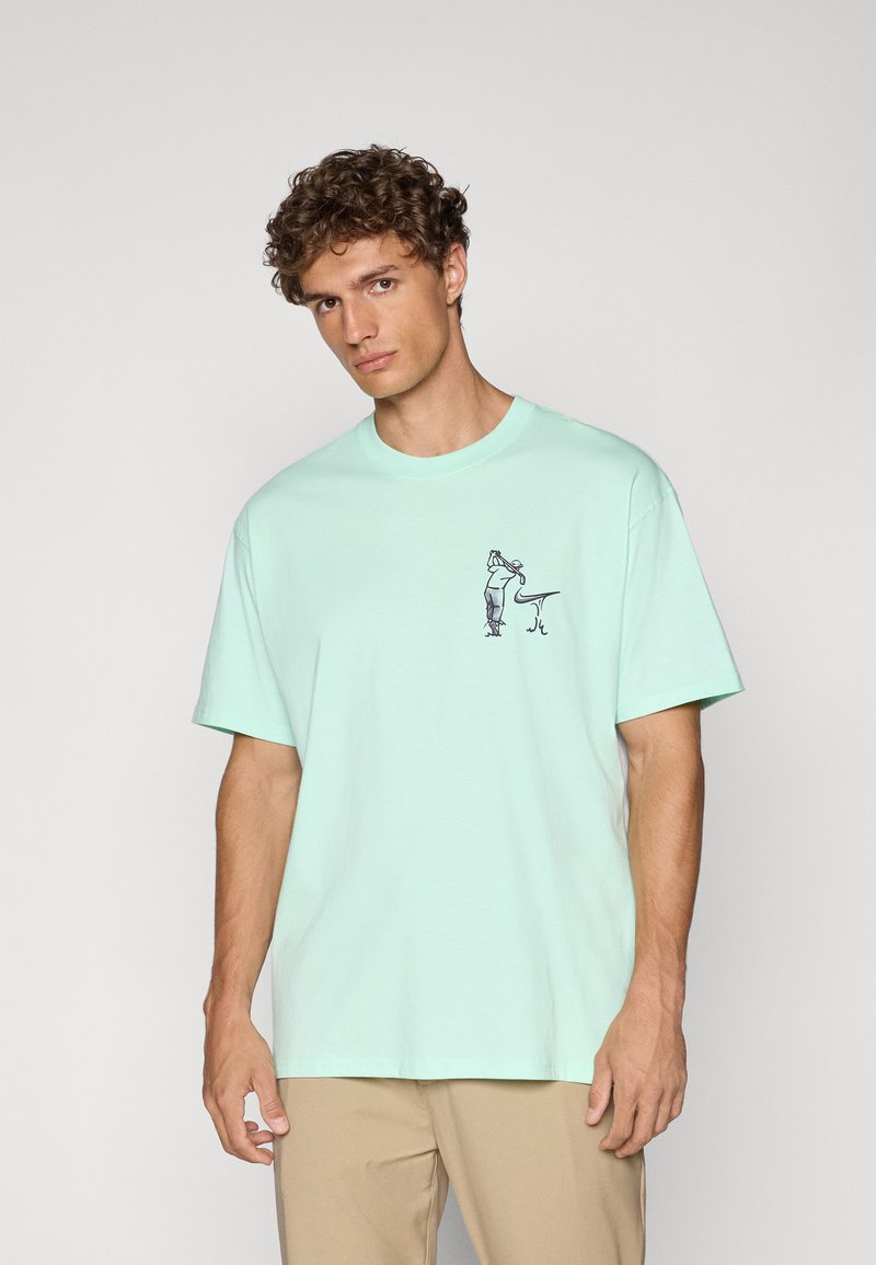 Mint green cotton t-shirt with a crew neckline, short sleeves, and a front graphic design featuring a figure and a stylized accent.