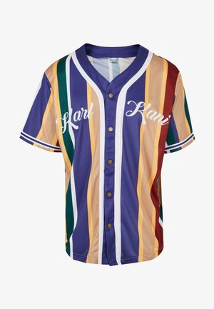 Rövid ujjú, gombos ing, többszínű függőleges csíkokkal, amelyek lila, zöld, sárga és piros árnyalatokban pompáznak. Hímzett "Karl Kani" felirat a mellrészén.