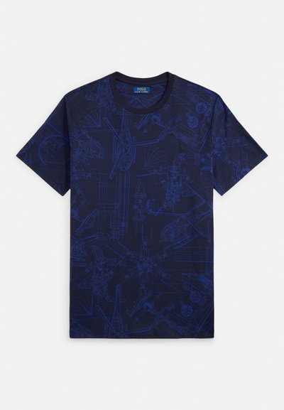 T-shirt azul-marinho com um gráfico em estilo de planta baixa em azul mais claro, apresentando designs mecânicos e ilustrações detalhadas. Mangas curtas, decote redondo.