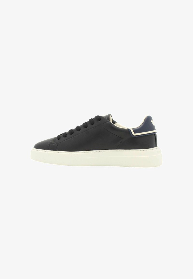 Sneaker in pelle nera con suola in gomma bianca, dotato di lacci neri, design minimalista e un accento blu navy sul tallone.