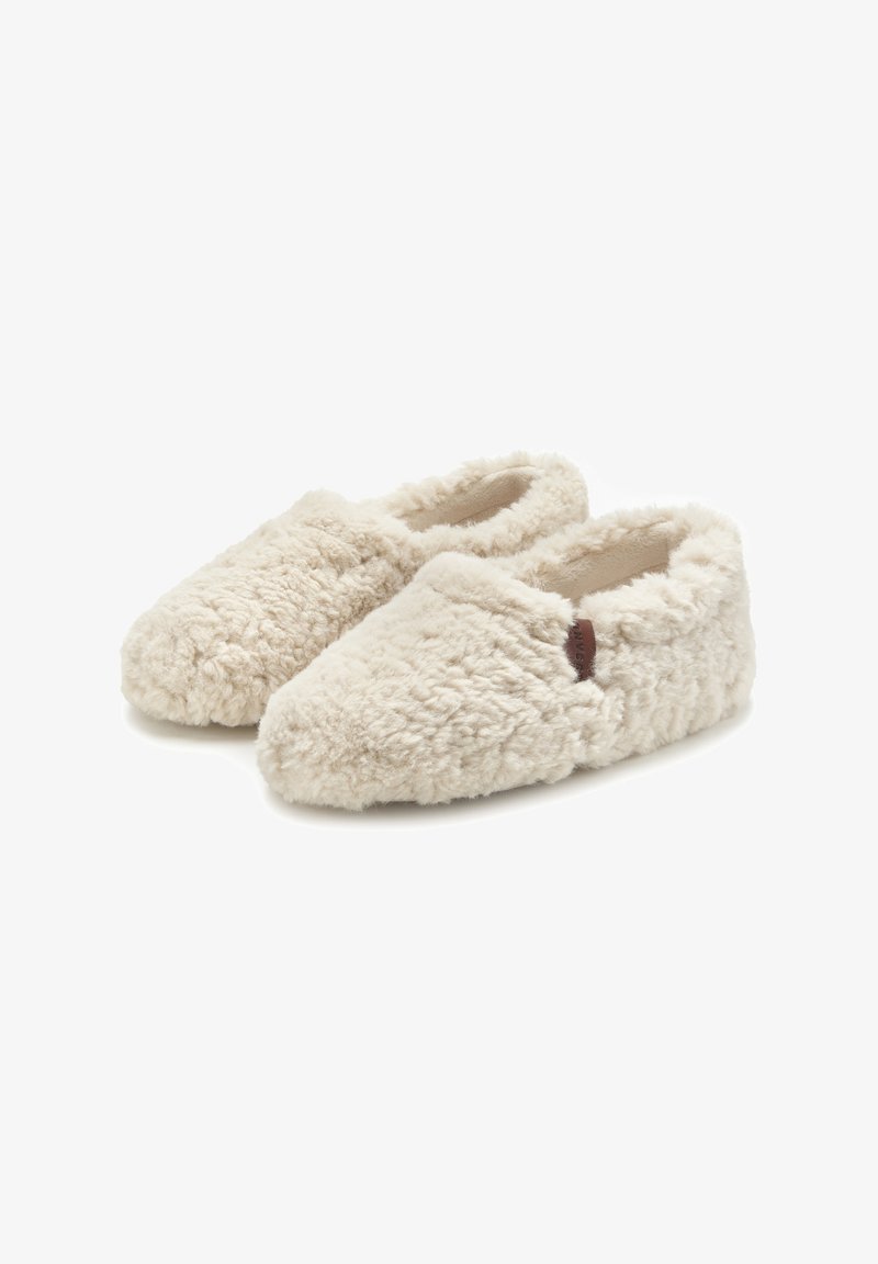 Cream-colored slippers with a fluffy texture and soft fabric, featuring a cozy design and a small leather accent on the side.