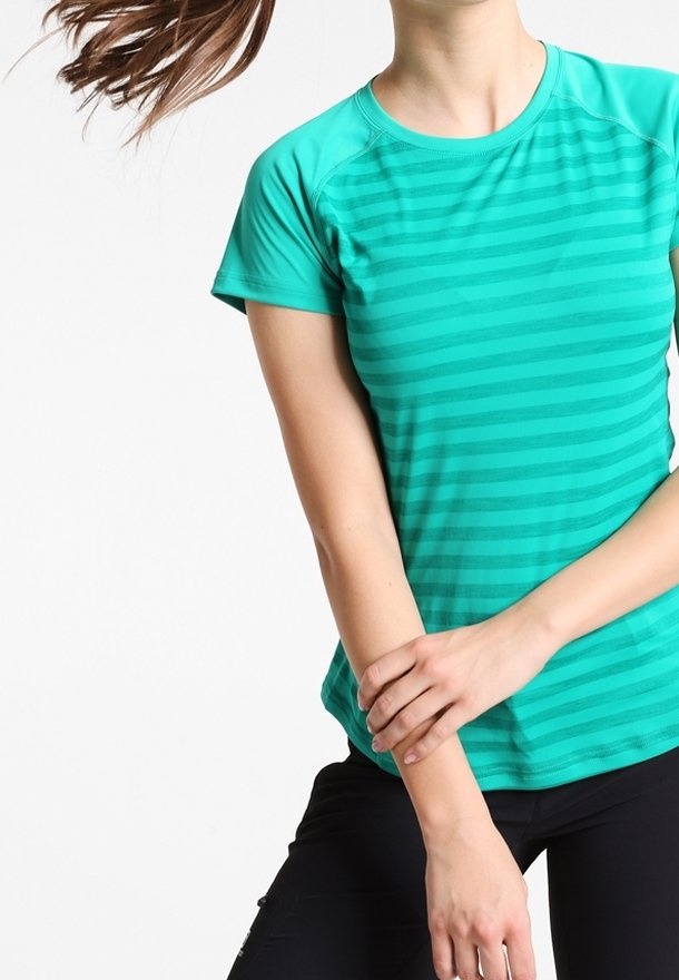 Grönrandig idrottströja med korta ärmar och rund halsringning, tillverkad av lätt tyg. Slät yta med något figursydd design.