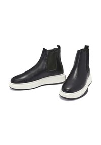 Black leather ankle boots with elastic side panels, a white midsole, and a textured black heel. Smooth finish, rounded toe design.