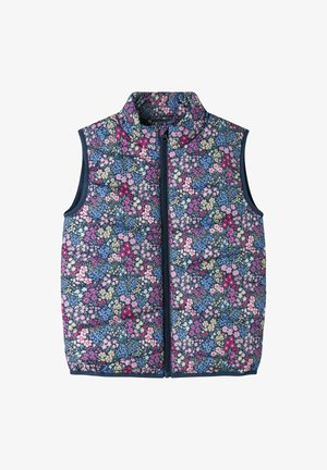 Gilet sans manches matelassé avec fermeture éclair, recouvert d'un motif floral dense présentant des fleurs roses, violettes, bleues et crème sur un fond sombre.