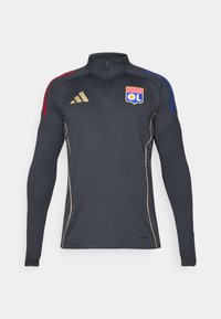 Sort atletisk zip-jakke med lange ærmer, der har røde og blå skuldre accentueret, guld piping og Olympique Lyonnais logoet.