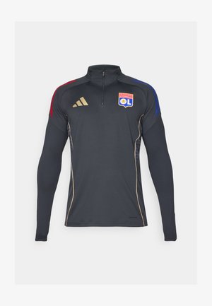 Veste zippée de sport noire à manches longues, avec des accents rouges et bleus aux épaules, un liseré doré, et le logo de l'Olympique Lyonnais.