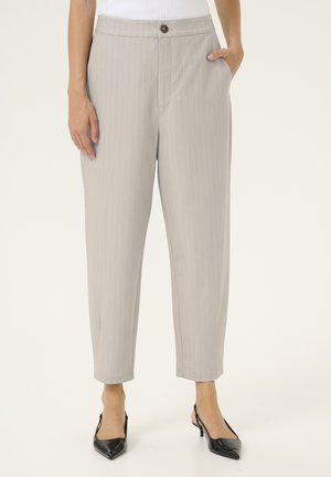 Light gray, pinstriped trousers with a drawstring waist, front pockets, and a button closure, paired with black pointed-toe heels.