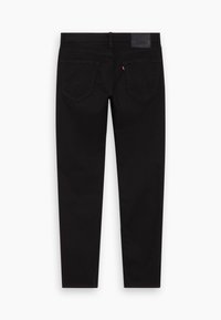 Jeans de mezclilla negra con corte ajustado, que cuentan con dos bolsillos traseros, un parche de marca de cuero y costuras en contraste. Textura suave.