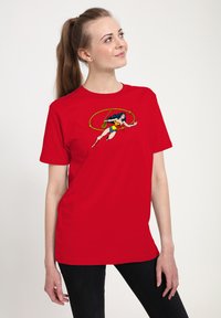 Red cotton t-shirt featuring a graphic of a superhero character in a dynamic pose, with a circular design behind her. Short sleeves, relaxed fit.