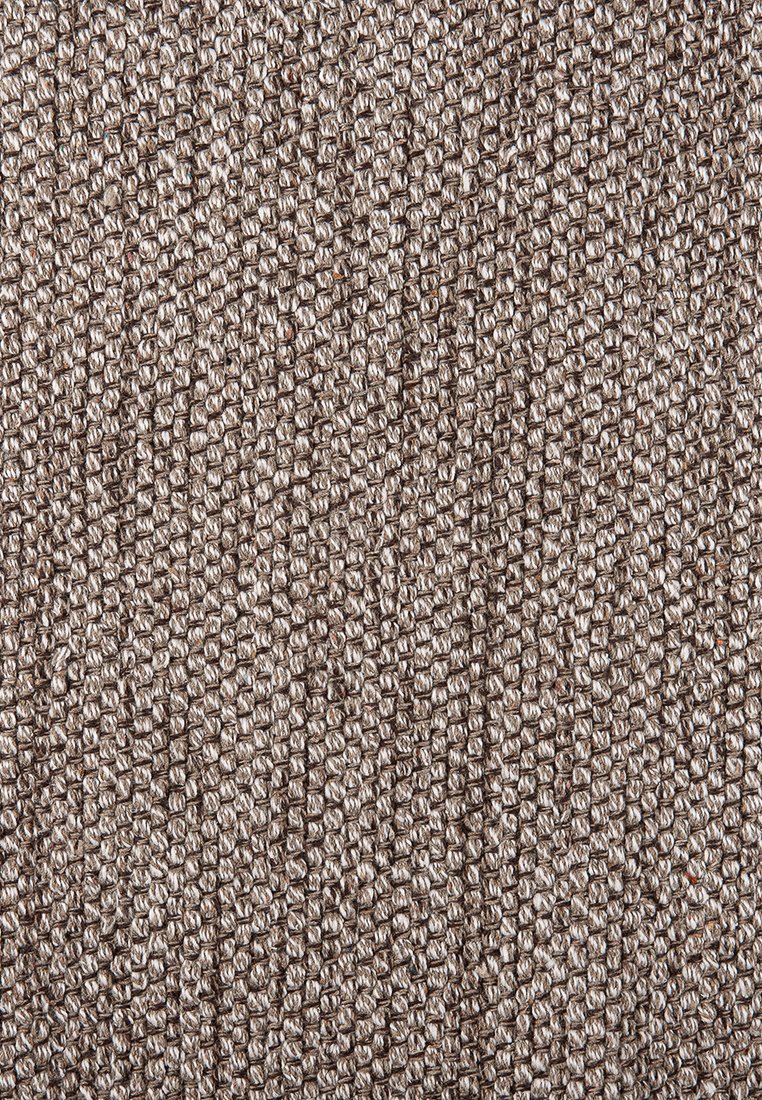 Texturovaná látka v neutrální béžové barvě, s tkaným vzorem a malými smyčkami, vytvářející hmatový povrch.