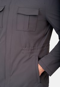 Gray lightweight jacket featuring a two-pocket chest design, side seam pockets, and smooth texture. Includes detailed stitching and a modern cut.