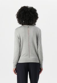 Gray sweater with a ribbed hem and cuffs; features a visible zipper along the center back. Soft texture and simple design.