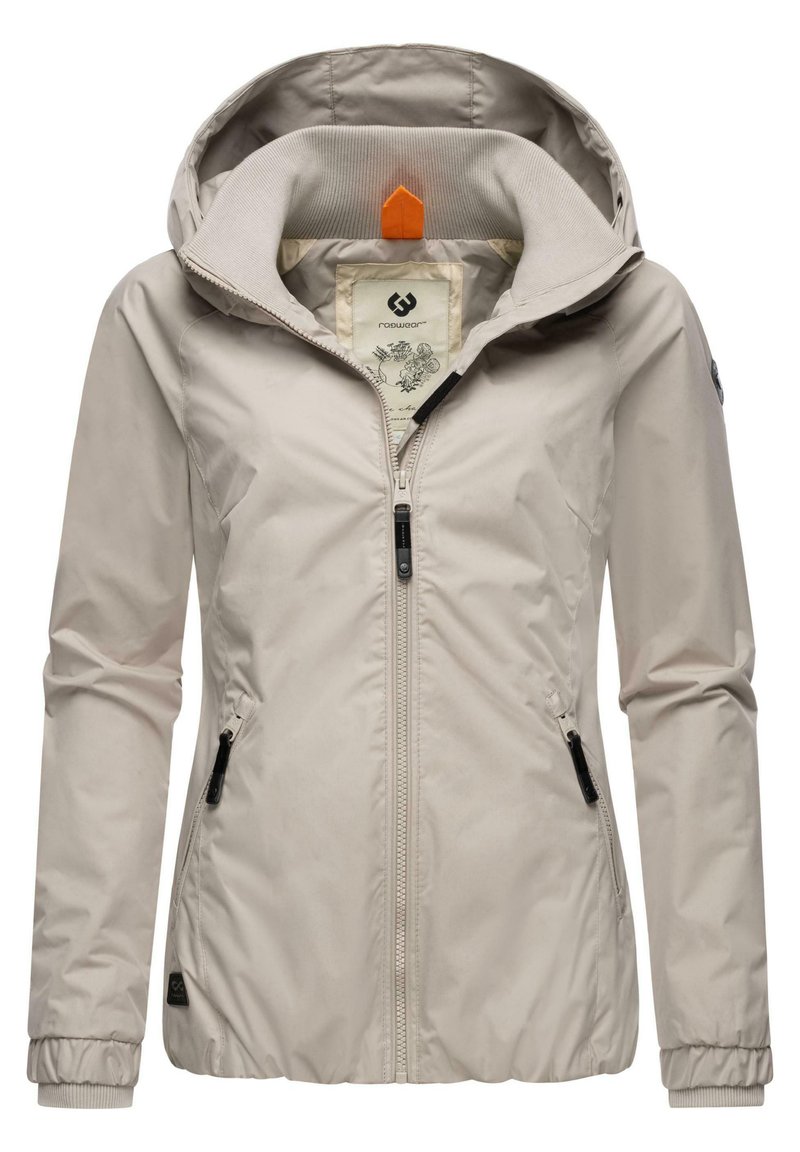 Lichtbeige jas met capuchon, voorzien van een rits aan de voorkant, twee zijzakken, geribbelde manchetten en een patroon binnenvoering. Oranje accent op de capuchon.