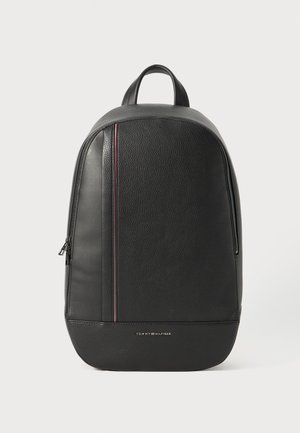 Black leather backpack with a vertical red and white stripe, top handle, side zipper, and small Tommy Hilfiger logo on lower front.