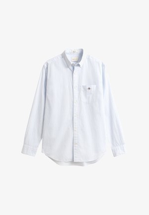 Světle modrá bavlněná košile s tenkými bílými pruhy, dlouhými rukávy, špičatým límečkem a kapsou s malým logem.