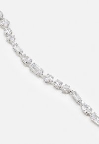 Silver-tone bracelet featuring a variety of clear-cut gemstones in different shapes, including oval, rectangular, and triangular.