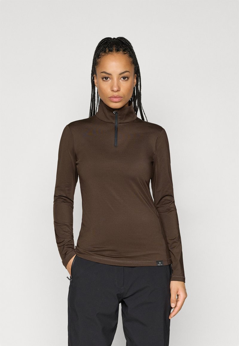 Καφέ μπλούζα με μακριά μανίκια, ψηλό γιακά και μπροστινό φερμουάρ. Διαθέτει απαλή υφή και εφαρμοστή γραμμή, ιδανική για στιλάτο layering.