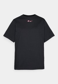 Black cotton T-shirt with short sleeves, featuring a small pink Nike logo and a minimalistic design. Smooth texture and crew neck.
