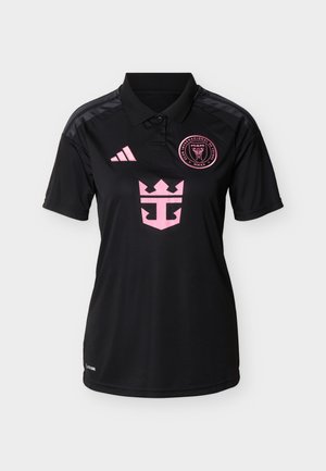 Black polo soccer jersey with pink Club Internacional de Fútbol Miami badge, pink Adidas logo, and pink crowned anchor emblem on the chest.