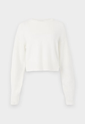 Valge lühendatud sviiter koos pikkade varrukatega, ribakujuline struktuur ja ümara kaelusega. Valmistatud pehmest ja kergest materjalist.