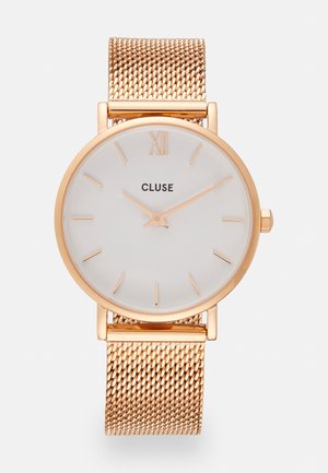 Round white watch face with gold hour markers and 'CLUSE' text. Gold mesh strap. Minimalist design, smooth metal finish, elegant texture.