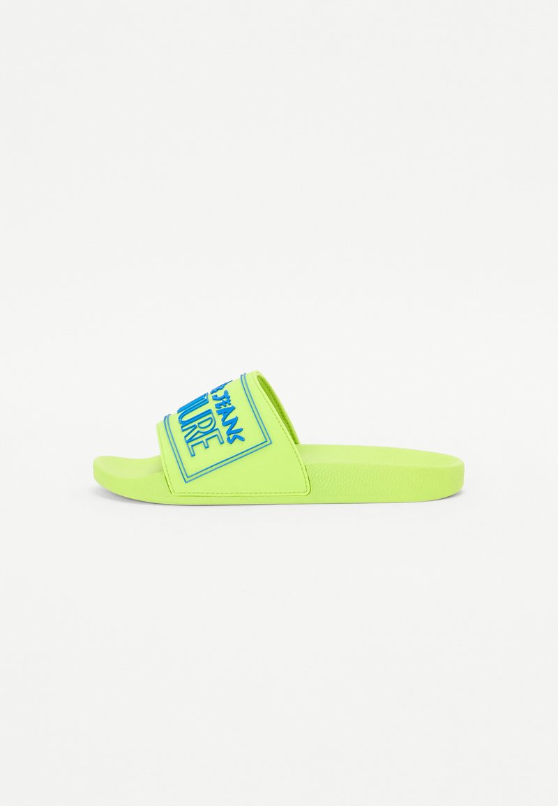 Infradito in verde neon con una larga fascia che presenta testo blu. Realizzato in materiale sintetico; suola piatta; design con punta aperta.