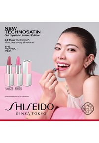 Woman applies pink lipstick from Shiseido's Technosatin Gel Lipstick limited edition, showcasing three matte and two shiny shades.