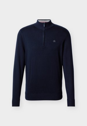 Tengerészkék hosszú ujjú pulóver negyed cipzárral és kis fehér "ck" logóval a bal oldali mellrészen, bordázott mandzsettákkal és szegéllyel.