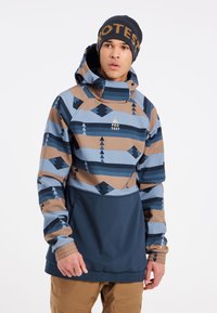 Veste à capuche colorée ornée de motifs géométriques bleus, bruns et crème. Texture lisse avec des poignets élastiques et une poche avant.