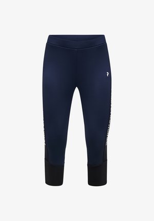Mørkeblå cropped sportsleggings med sorte ankelmanchetter og hvidt logo på venstre lår, tekst delvist synlig på sidepanelerne.