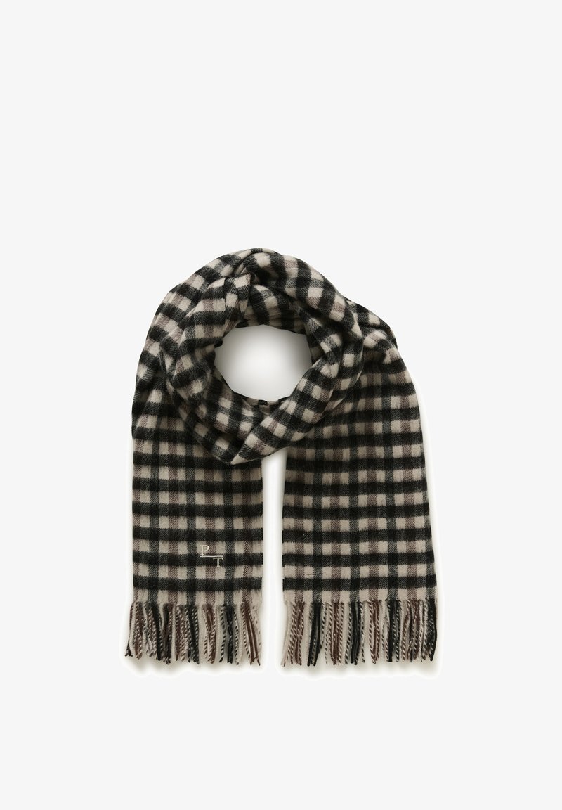 Écharpe en laine à carreaux noirs, blancs et beiges avec des franges aux extrémités, bouclée librement en forme de cercle.