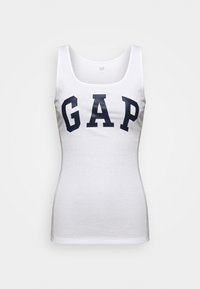 White cotton tank top with a round neckline, featuring a navy "GAP" logo in bold text across the chest. Ribbed texture and slim fit.
