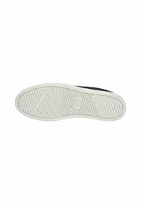 Sneaker nera con suola in gomma bianca. La suola presenta un motivo a zigzag per la trazione. La tomaia ha un design semplice e privo di decorazioni.