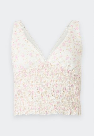 Valge lühike tanktop, roosa-beežide lillemustriga, V-kaeluse ning króolitud tekstuuriga pluusiosa.