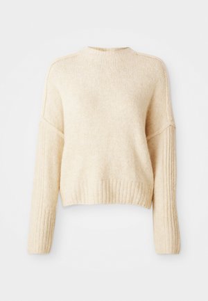 Pulover tricotat de culoare crem, cu manșete și tiv cu dungi, având un design ușor scurtat și o croială lejeră. Textură moale, fără modele.