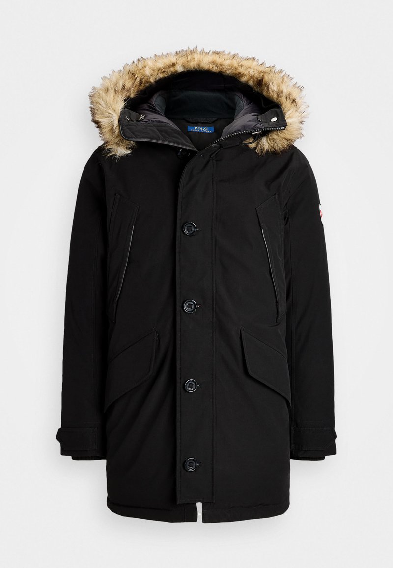 Giacca parka nera con cappuccio foderato in pelliccia sintetica, chiusura a bottoni, due tasche anteriori e tasche laterali con zip. Tessuto testurizzato con finitura opaca.