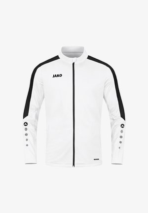 Weiße Sportjacke mit schwarzen Akzenten, hohem Kragen, durchgehendem Reißverschluss und einzigartigem Knopfdetail an den Ärmeln. Mit "JAKO"-Logo auf der Brust.