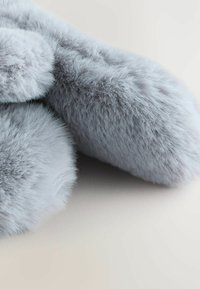 Light gray faux fur with a dense, soft texture, featuring smooth, rounded edges and a layered appearance. The background is neutral.